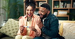 Happy couple, pregnancy test and positive with surprise on sofa for motherhood, fatherhood or expecting at home. Excited man and woman with smile for pregnant results, exam or soon to be parents
