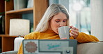 Woman, relax and laptop with coffee on sofa for morning, online browsing or checking email at home. Young female person with warm beverage, drink or tea on computer for communication in living room