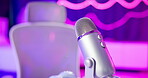 Microphone, live stream and recording studio in neon room for podcast, broadcast show and vlogging on air. Influencer equipment, interior and closeup of tech instrument for social media entertainment