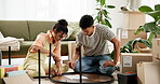 Couple, assemble table and move in to new home for renovations, relocation and furniture building. Relationship, man and woman together with boxes for bonding, support and partnership with love