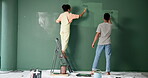 Back, couple and renovations with painting on wall in new home or house for diy or makeover. People, relationship and love with fun to enjoy, support and care for teamwork, collaboration and decorate