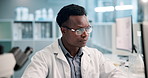 Science, research and black man in laboratory with computer for results, ideas and medical study. Technology, scientist or lab technician reading web review, report or data on pharmaceutical study