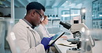 Science, lab and black man with microscope and tablet for online research, medical results and vaccine. Healthcare, biotechnology and scientist on digital tech for study, experiment and sample report