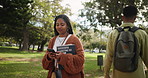 Phone, search and black woman with book at campus park for reading, info or university newsletter sign up. Education, college or marketing student walk with smartphone for location, map or direction