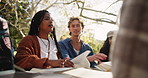 Students, laptop and talking outdoor for study break with books and learn for english assessment or test. Computer, gen z people and friends conversation in park for college education and knowledge