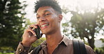 Happy man, student and walking with phone call at park for conversation, communication or outdoor chat. Young male person talking on mobile smartphone with smile for friendly discussion in nature