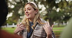 Happy woman, student and talking with friends at park for communication, social or gossip in nature. Young female person speaking to group for outdoor discussion, chat or conversation on grass field