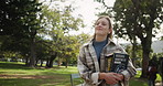 Happy woman, student and walking with books in nature for learning, education or commute at outdoor park. Female person or learner in stroll with smile or textbooks for studying at campus or college