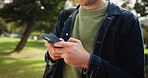 College student, hands and man with phone in campus park with social media, chat or location search. University, smartphone and student with app for elearning tutor, research or scholarship sign up