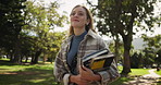 Happy woman, student and walking with books in park for learning, education or path to university. Female person in stroll with textbooks at outdoor campus or college for academic journey in nature