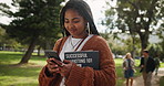 Black woman, student and walking with phone or books in nature for learning, education or studying at outdoor park. Young African with smile on mobile smartphone for online browsing or communication