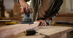 Carpenter, hands and sanding with electric tool for construction, furniture or project. Closeup of person smoothing wood with sandpaper in creative carpentry workshop for manufacturing, art and craft