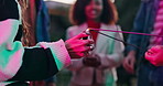 Sparklers, lighter or hands of people in celebration with flame, party or sticks in night on new years. Group, closeup or friends in urban city together for social event, fun fireworks or burning