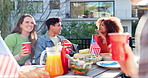 Friends, celebration and meal on independence day, outside and lunch with American flag for culture party. National holiday, tradition and USA country pride, people and food or discussion in garden