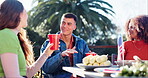 People, party and food on independence day, outside and lunch with American flag for happy culture. National holiday, tradition and USA country pride, friends and meal celebration for discussion