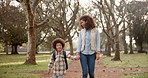 Black mother, child and holding hands with backpack in forest for safety, bonding or walk to school. African mom, little boy or kid in support, love or care in nature or park with bag to kindergarden