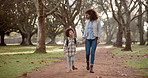 Black mother, walking and holding hands with backpack in forest for safety, bonding or path to school. African mom, little boy or kid in support, love or care in nature park with bag for kindergarden