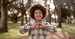 Happy, black child and nature with heart hands for love, vote or outdoor review in nature. Portrait of young African, little boy or kid with smile, like emoji or sign in care at park, forest or woods