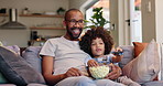 Happy father, child and watching tv with popcorn for entertainment, bonding or movie on sofa at home. Dad, kid or little boy with smile or remote for online streaming, show or cartoon in living room