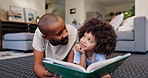 Home, father on floor and boy reading book, love and storytelling with smile, happiness and bonding together. Family, parent or dad with kid, son or childhood development with knowledge, joy or break