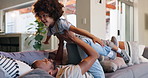 Happy, father and playing airplane with child for bonding, fun and support with rest and relax at home. Black family, son and dad with balance game on sofa for love, excitement and time together