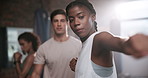 Woman, training and personal trainer with boxer for self defense, workout or exercise at indoor gym. Female person or fighter with coach for punching, martial arts or boxing together at health club