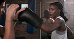 Gym, boxing and coach with woman for punching, exercise and training class. Fitness center, female client and male personal trainer for supervision, teaching and motivation for beginner boxer