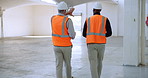 Construction, communication and men with teamwork in warehouse for project, update or feedback. Contractor, inspector and people with discussion on site for property, inspection and civil engineering