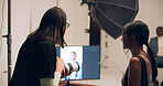 Woman, camera and model in studio talking for creative direction, production or videography on set. Tech, female person or entrepreneur with artist discussion for social media post or online magazine