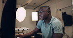 Photography, man and editing on computer in studio with production process, image retouch and catalog inspection. Photographer, african person or typing on pc backstage for creative photoshoot review