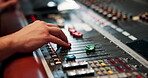 Studio, hand and engineer with music equipment for volume level, frequency mode and control. Person, sound producer and audio mixer for track record, consistency and creativity with workstation
