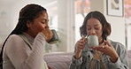 Coffee, friends and women on sofa for conversation, talking and chat for social visit in home. Living room, happy and people on couch with drink, caffeine and beverage for bonding, relax and wellness