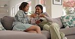 Women, friends and sharing on sofa with phone, relax or reading with meme, chat and funny video on web. Girl, people and smartphone on living room couch for streaming, post and social network on app