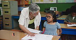 Woman, child and helping with paper in classroom, support and teaching reading for education knowledge. Student, teacher and notebook study, assessment and language test for learning development goal