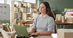 Distribution, call center and woman with online order help and inventory check with telemarketing at desk. Talking, work and customer support with digital delivery reference at office with crm