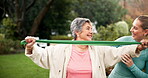 Exercise, elderly woman and trainer with senior care in garden, support and physio at nursing home. Help, wellness and female trainer with patient for muscle health, rehabilitation and progress