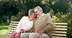 Senior couple, park and smile in bench for bonding, love and retirement in New York. Relationship, people and happy with forehead touch as pensioner for mindfulness, trust and support in outdoor