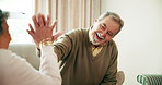 Senior, couple and relax on sofa with high five for victory of board game, playful competition and elderly entertainment. Old man, woman and hand gesture in retirement home for support with love.