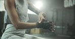 Gym, hands and person with gloves for workout, injury prevention and comfort during training. Health club, preparation and female bodybuilder for exercise, wrapping cloth and protection for fitness