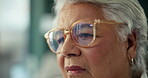 Home, thinking and senior woman with depression, reflection and remember past memory. Retirement, alzheimer and sad person in glasses with vision, lonely and regret decision with closeup of face