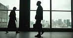 Walking, office and silhouette of man in window, thinking and moving in law firm. Male lawyer, colleagues and lobby in building for scheduled meeting, professional and confidence in workplace