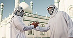 Muslim, religion and men by mosque with handshake for community, hello and greet Islamic friends. Religious, prayer and people talking for Ramadan Kareem, Eid Mubarak and praying in Saudi Arabia