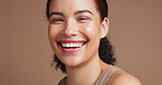 Woman, face and laughing in studio for skincare, makeup and self care on brown background. Female person, portrait and confident in dermatology or foundation glow, facial treatment and wellness