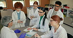 Teacher, students and learning in science classroom for education, experiment and knowledge. Teenager, people and classmates with chemicals at lab in high school as future scientist for research