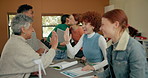 Happy students, celebration and high five with teacher for winning, congratulations or success in classroom. Young group of excited learners touching hands for achievement, good news or results