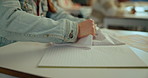 Classroom, frustrated and student tearing book on desk with exam stress, studying and notes. Education, mistake and angry teenager person with crumpled paper, burnout and mental health at high school