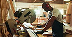 Black man, circular saw and lumber for construction, building or project for material, craft or supplies. Male person, woodcutter and manufacturing for contractor, industry or carpentry in warehouse