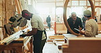 Mentor, working and carpenter with wood in workshop for furniture manufacturing for business. Men, internship and project manager training industrial apprentice with timber material in warehouse.