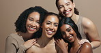 Face, women or diversity in studio for glow, skincare or wellness with smile, inclusion for cosmetics. Support, hug and happy people with group, beauty results for dermatology on brown background