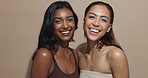 Face, women or smile in studio for makeup, skincare or wellness with diversity, inclusion for cosmetics. Support, hug and happy people with glow, beauty results for dermatology on brown background